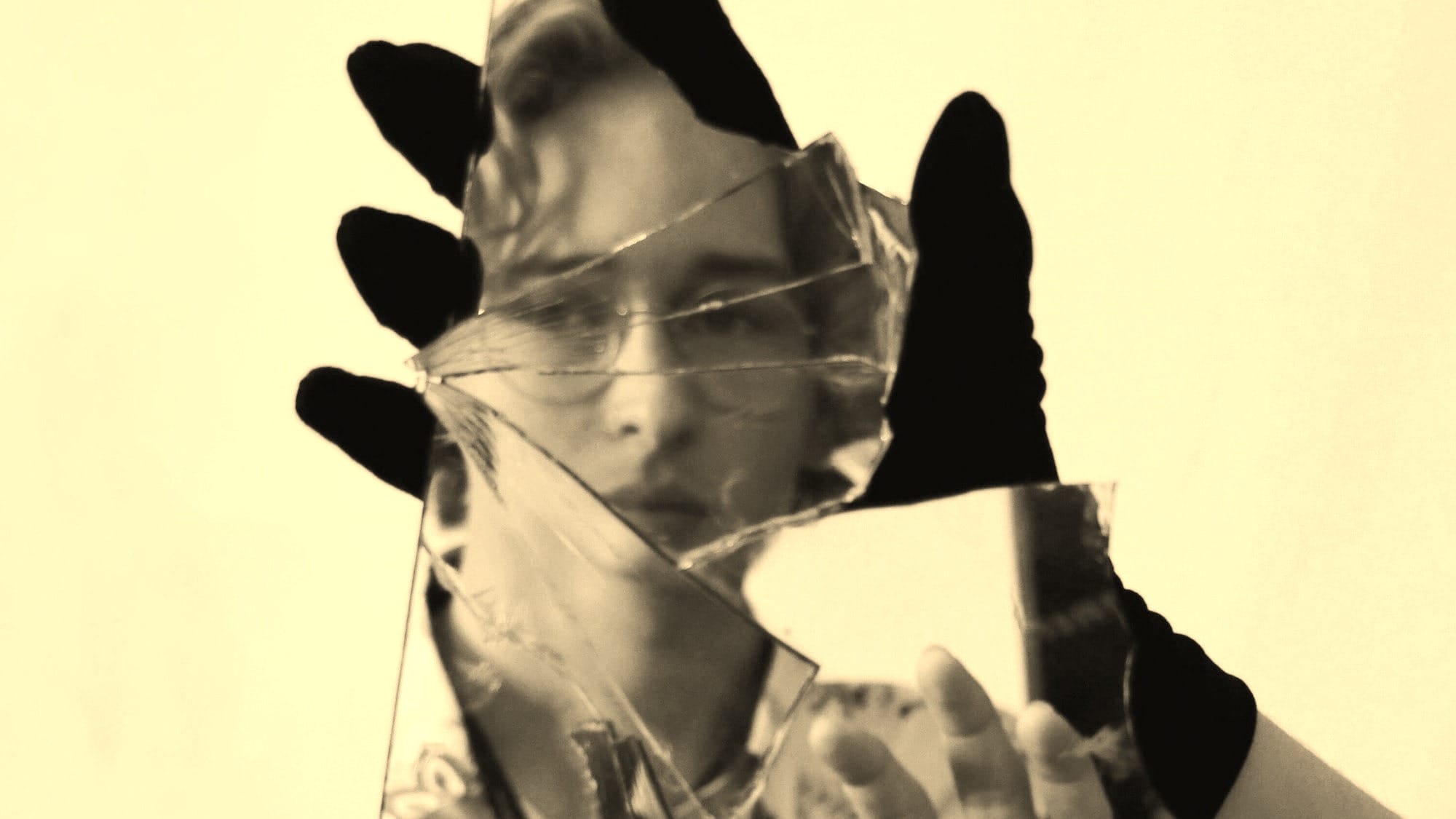 woman in black shirt covering face with hands